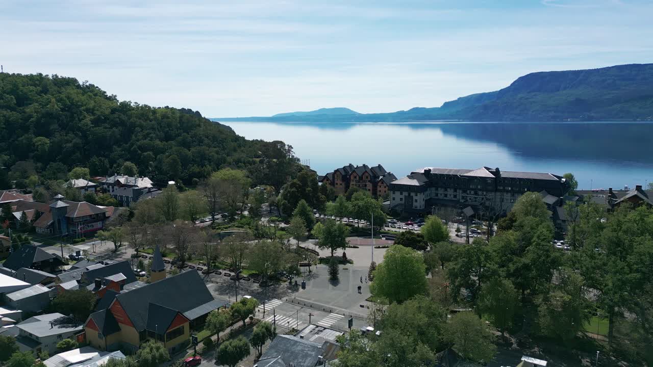 Aerial view of Pucon’s main square and calm lakefront with surrounding hotels and forested hills