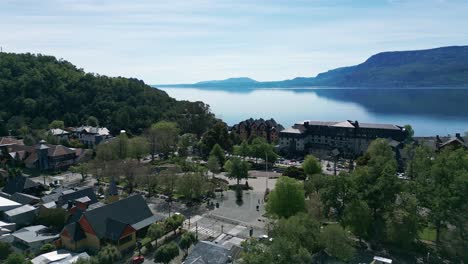 aerial view of pucon’s main square and calm lakefront with surrounding hotels and forested hills