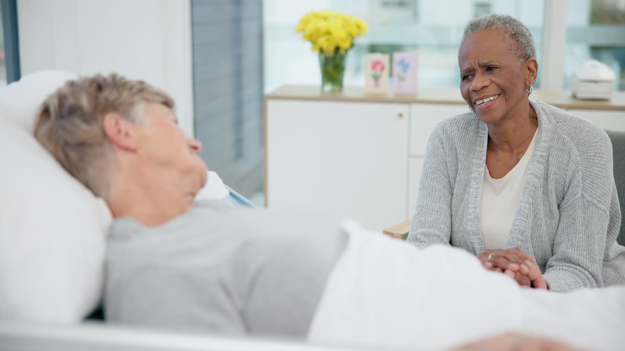 Elderly women friends, hospital bed