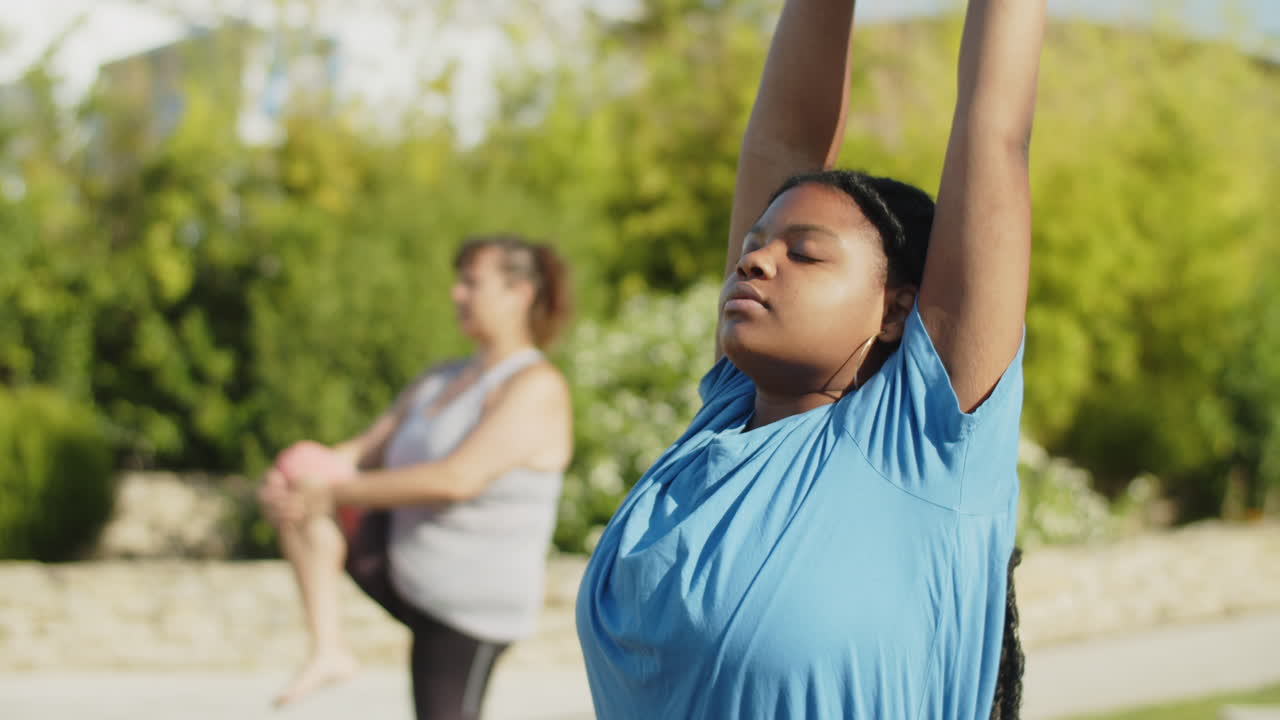 Medium shot of focused woman raising up and stretching arms