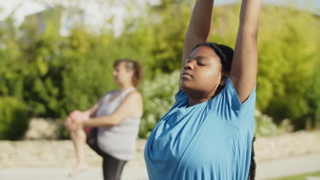 medium shot of focused woman raising up and stretching arms