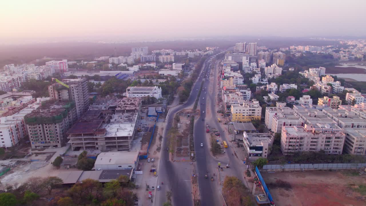 residentials buildings with medchal road, vehicles, and under construction building at jeedimetla village, suchitra, hyderabad, telangana, india. day time, push in, tilt up, drone shot, 4k.