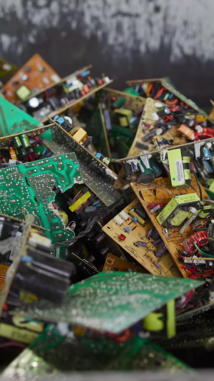 Closeup Bin Of Circuit Boards Inside Sorting Container, Detailed View Of Capacitors, Coils And Solder Joints,