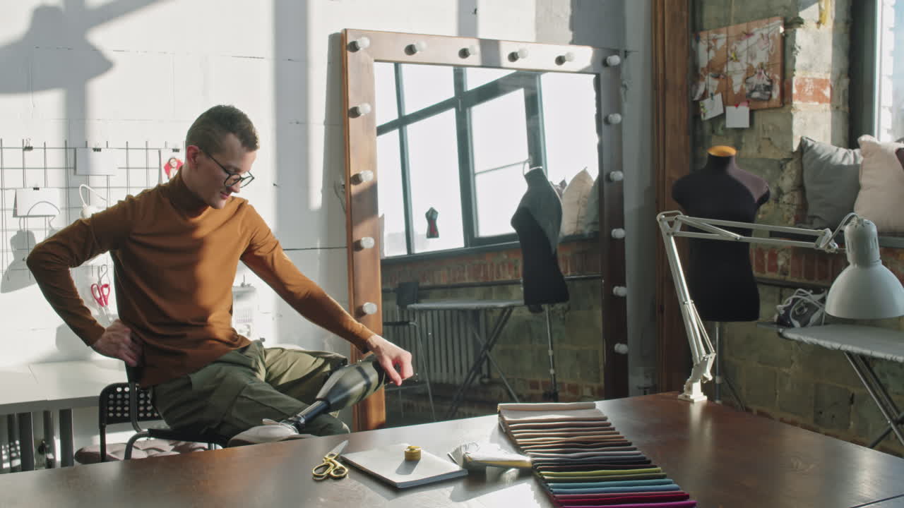Fashion Designer with Prosthetic Leg Posing in Workplace
