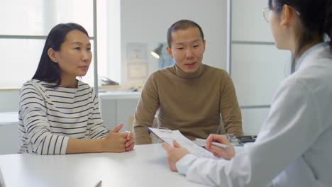 asian couple on consultation in fertility clinic