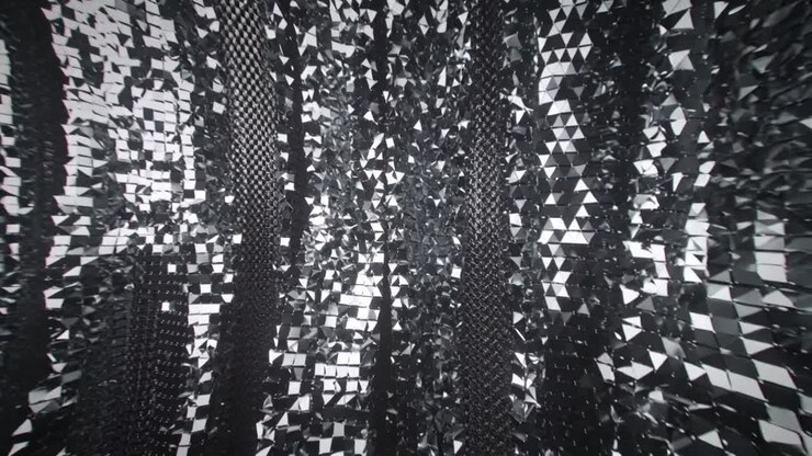 Moving camera revealing reflective faceted surface rippling into checkerboard mosaic at dark void