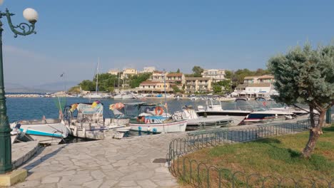 row of picturesque traditional fishing boats moored together at kassiopi village