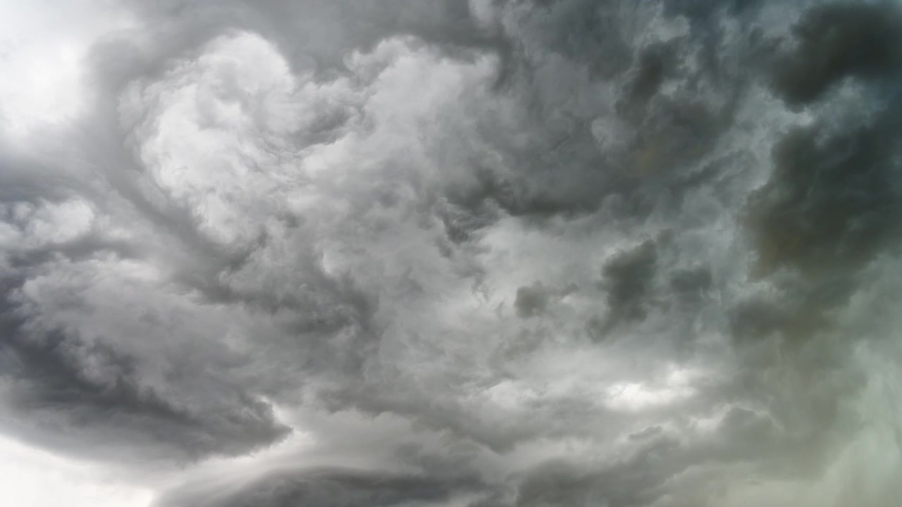 Atmospheric storm clouds moving slowly across dramatic grey sky