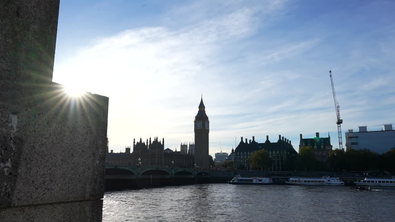 Sunlight over Thames River with Big Ben and Parliament in view on a clear day in London