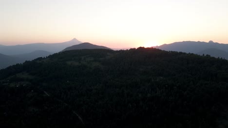 aerial panoramic of the golden hour between mountains and the villarrica volcano in the background - drone shot