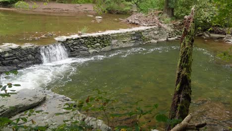 Waterfall-near-Covered-Bridge,-Thomas-Mill-at-the-Wissahickon-Creek