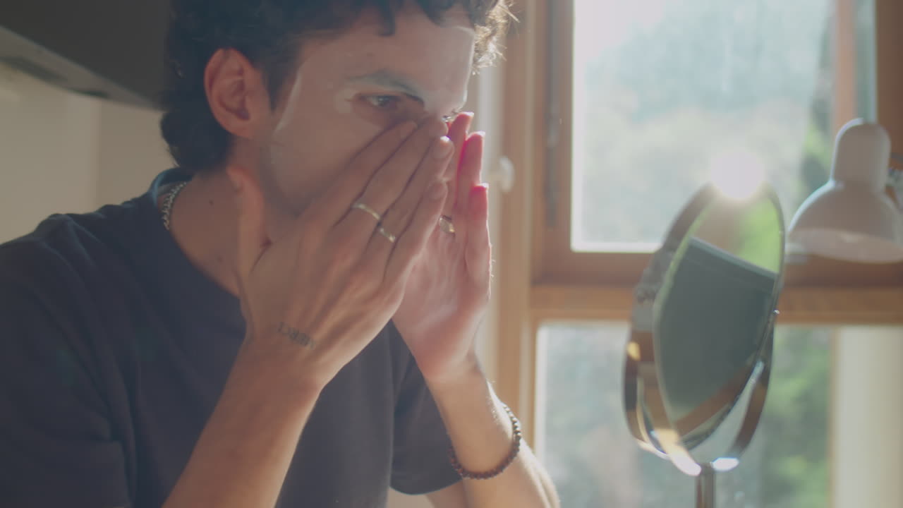 Man Using Facial Sheet Mask at Home