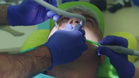 root canal treatment process. doctor hands drilling teeth