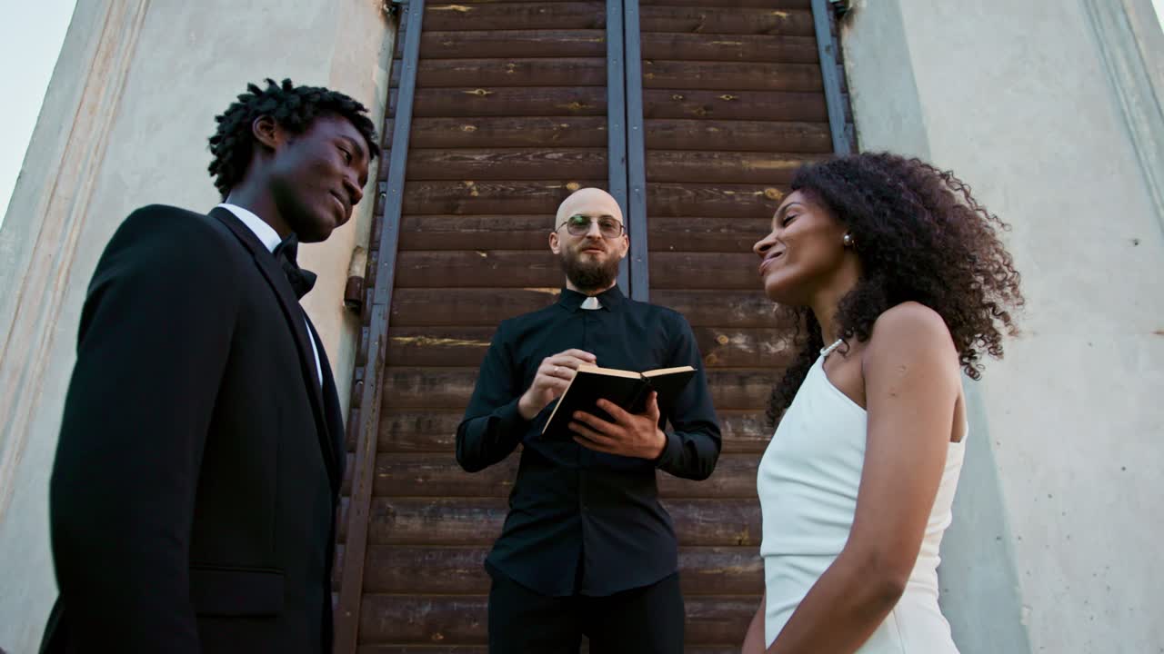 Wedding ceremony with bride, groom, and priest