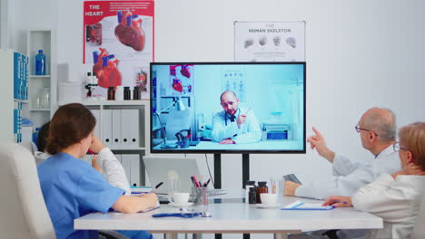 medical people holding online meeting in boardroom with man specialist doctor