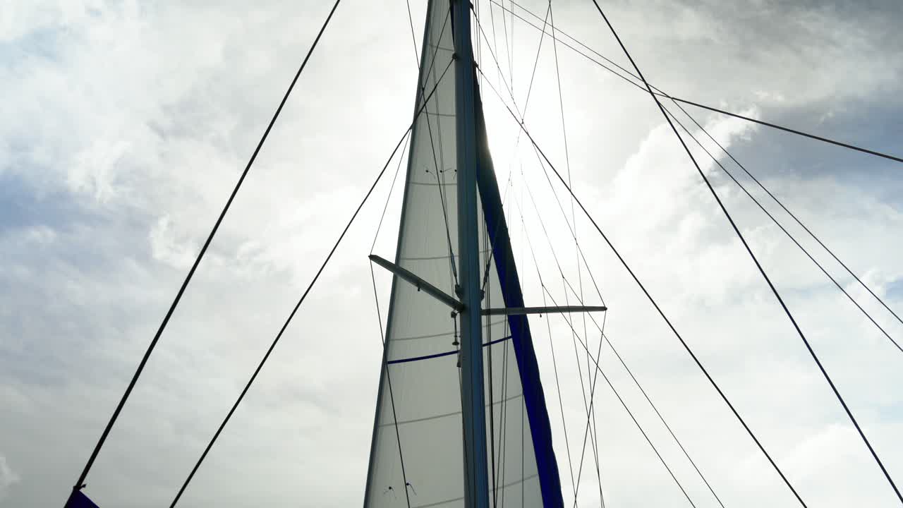 Sails and lines of boat against the sky, a storm is coming