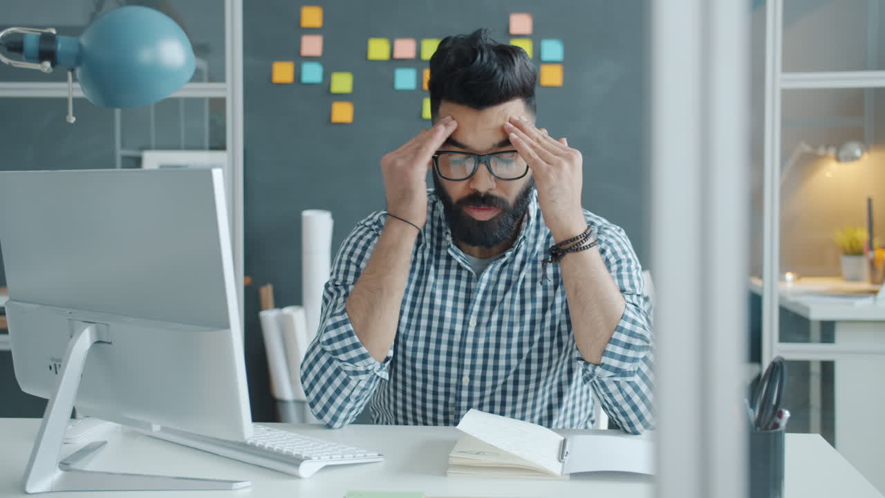 Man Working at a Computer, Stressed