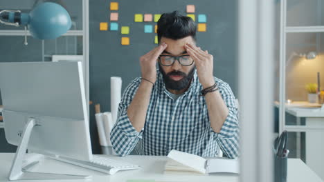 man working at a computer, stressed