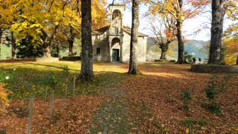 autumn vibes in metsovo walking through the orange lives with a church in background