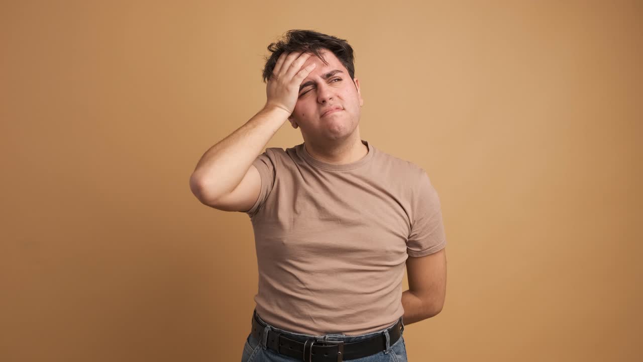 Young man feeling sick hands on head