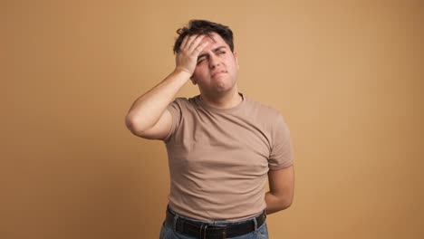 young man feeling sick hands on head