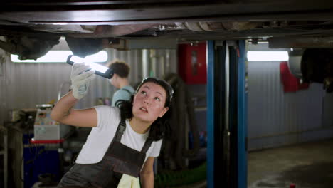 woman inspecting automobile