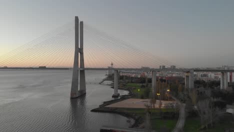 vasco da gama bridge and lisbon coastline at sunset, portugal