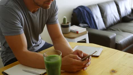 Man-using-mobile-phone-in-living-room-4k