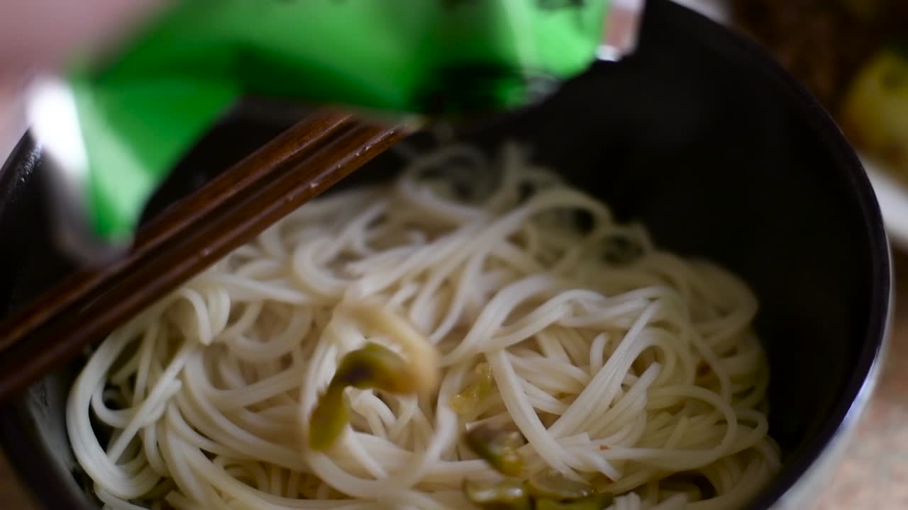 Topping my noodles with some tasty Chinese toppings. Shot in slow-motion.