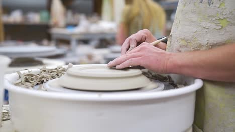 ceramics pottery crafting wheel of clay spinning to make an artistic clay plate forming a creative piece of pottery