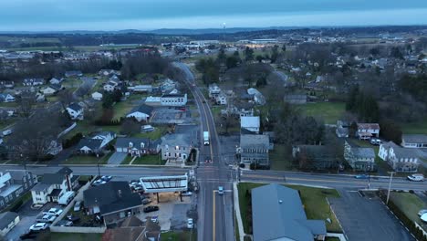 Cars-driving-on-main-road-in-small-american-town-in-winter-season