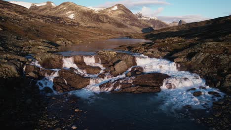 epic waterfall in norway during sunrise