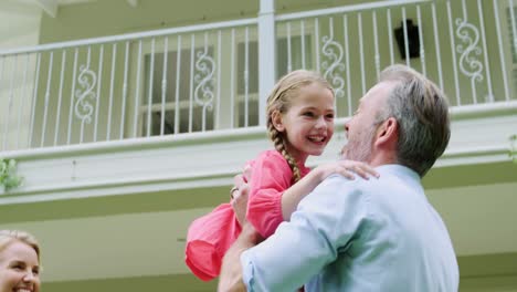 family enjoying fun outside house