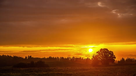 sunrise on a cloudy day over the countryside - time lapse