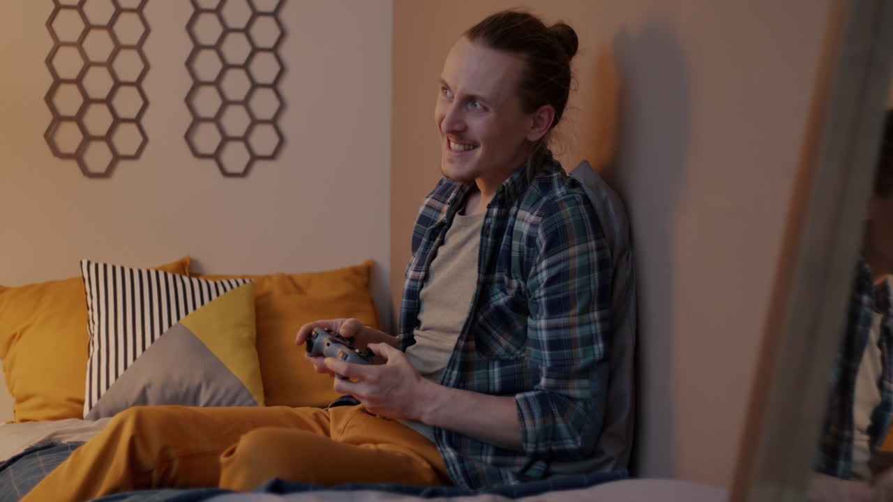 Man Playing Video Games in His Bedroom