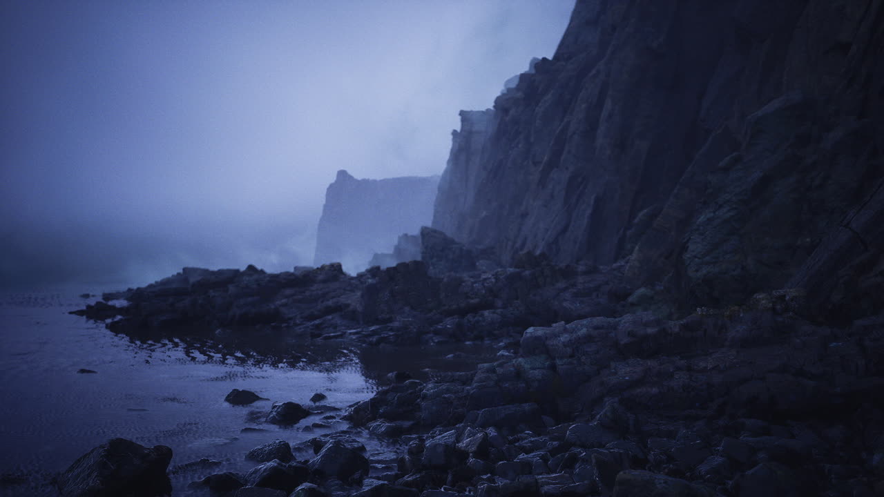 Faintly visible coast with smooth stones and serene blue waters