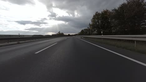 first person view of driving over a german highway on a cloudy day, 4k