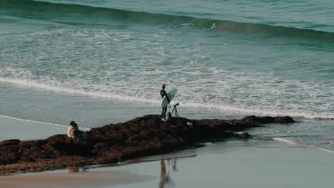 a surfer looking out for waves on a beach in marokko