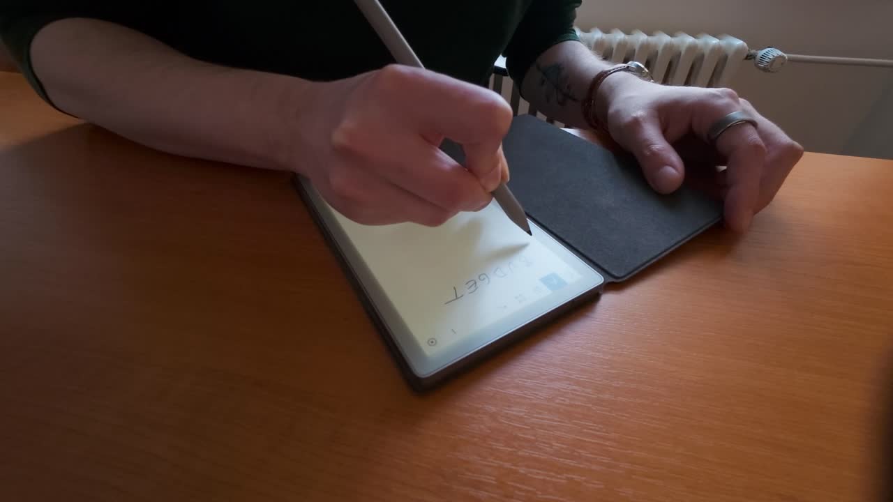 A man creates a budget using a digital notebook. Important items for understanding finances