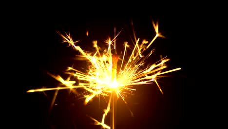 yellow sparklers is sparkling on black background 4k