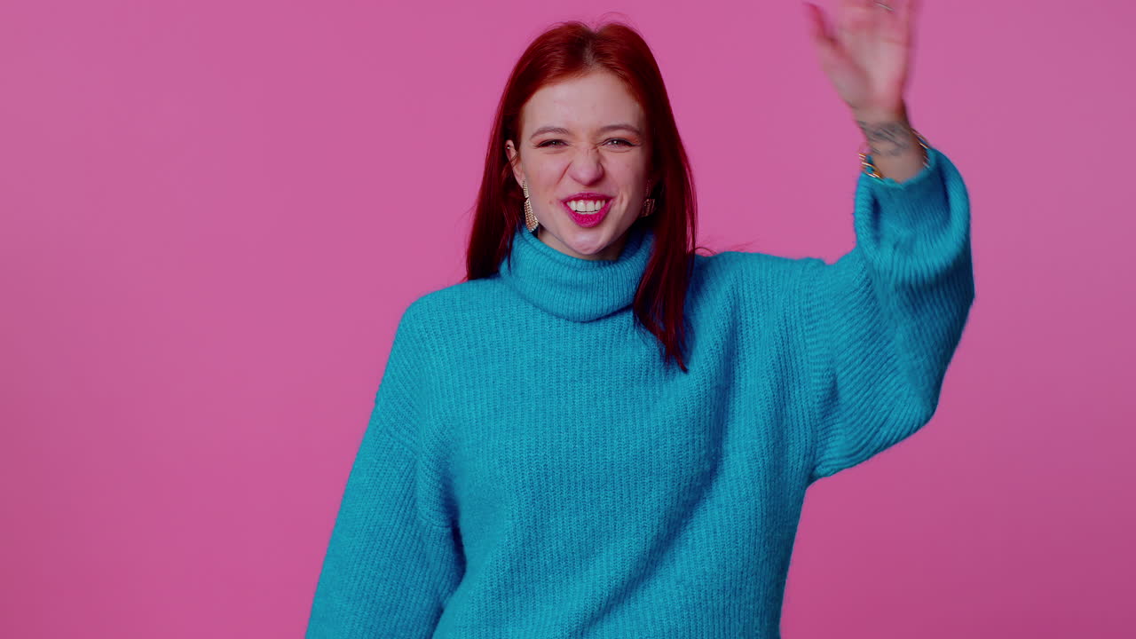 Girl teenager smiling friendly at camera and waving hands gesturing hello or goodbye, welcoming