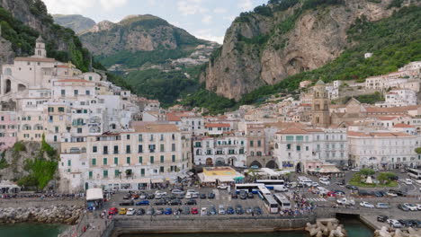 Aerial:-Backwards-reveal-drone-shot-of-Amalfi-village-in-Italy