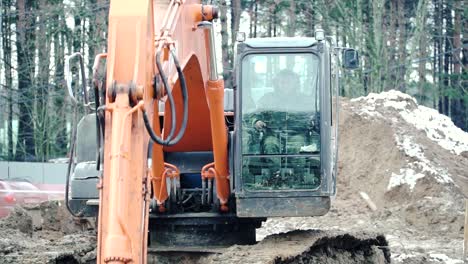 excavator working on a construction site in winter