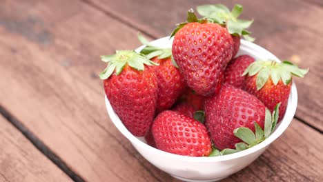 ripe red strawberries in a bowl on table