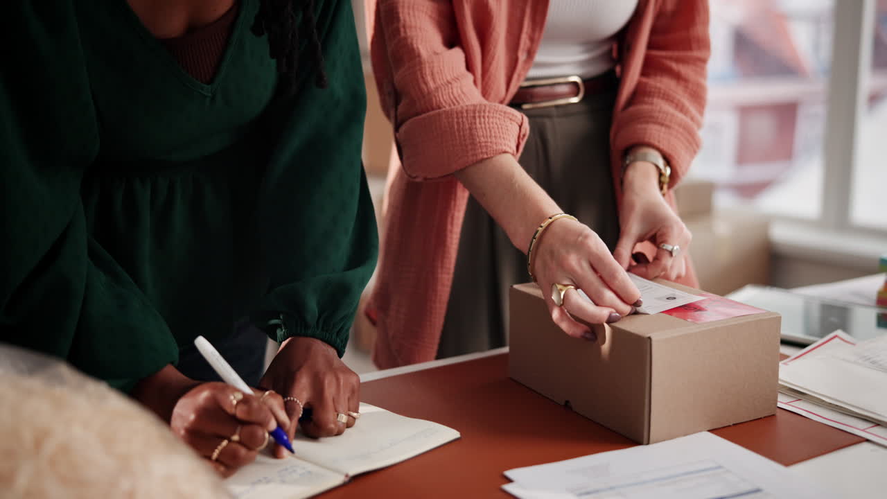 Women Preparing Packages for Shipping in a Small Business Office