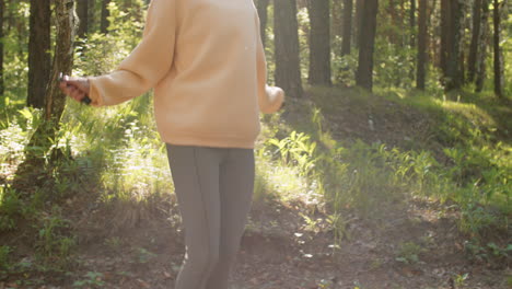 woman jumping rope in a forest