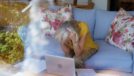 Worried-senior-woman-sitting-on-sofa-4k