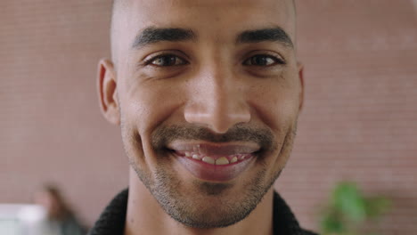 close up portrait of handsome young mixed race man in contemporary office workspace smiling happy enjoying start up business