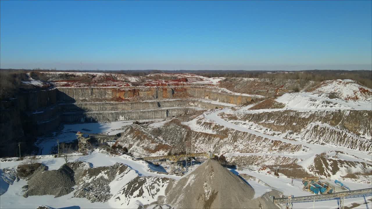 Aerial flyover of a quarry in the snow