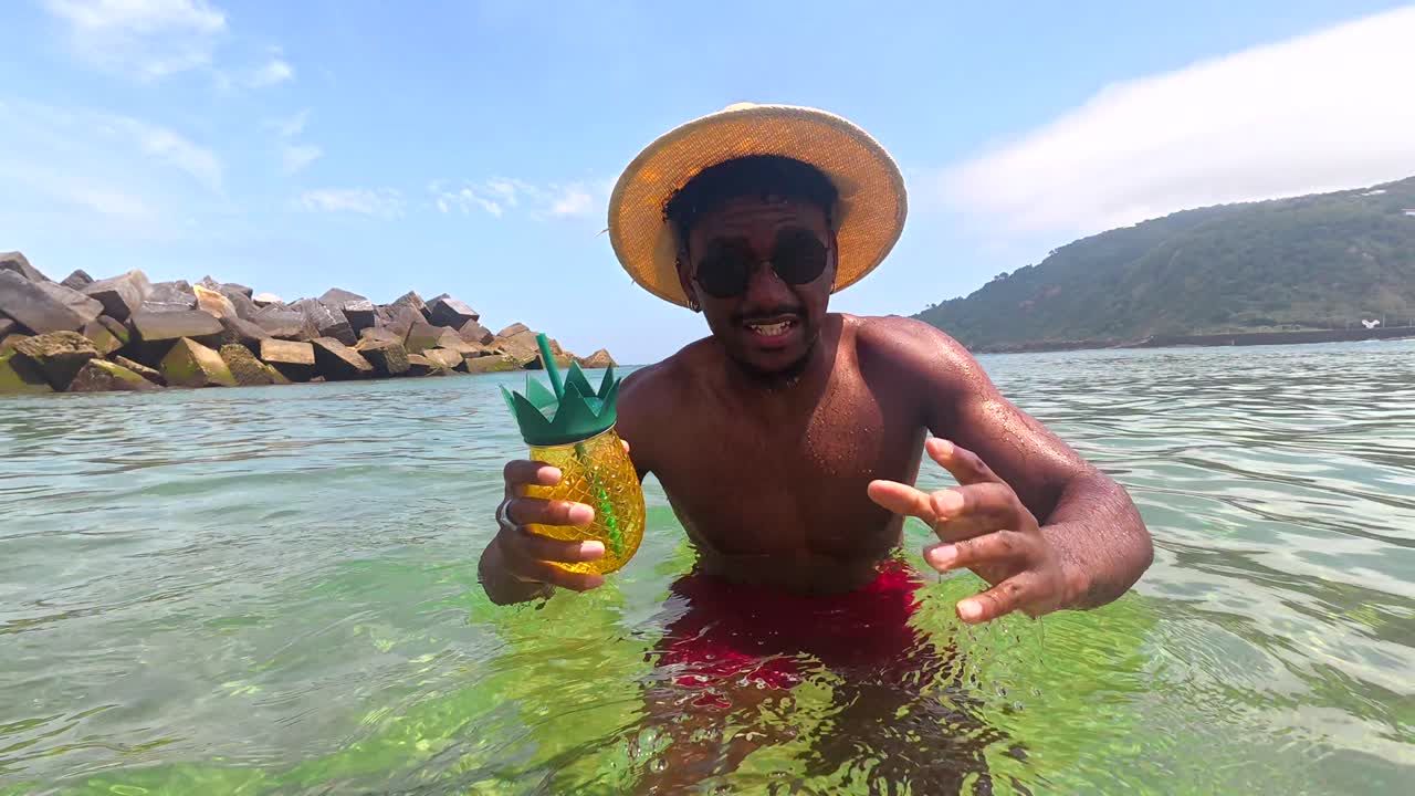 Man enjoying a tropical drink at the beach